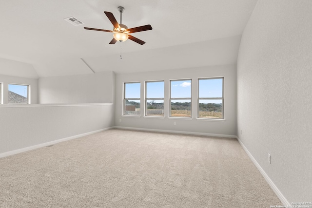 spare room with light carpet, baseboards, visible vents, and a healthy amount of sunlight