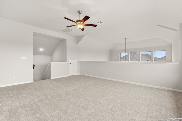 bonus room with carpet floors, visible vents, vaulted ceiling, and baseboards