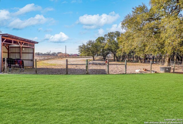 view of yard with an outbuilding and a rural view