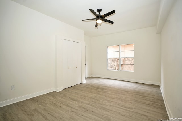 unfurnished room with hardwood / wood-style flooring and ceiling fan