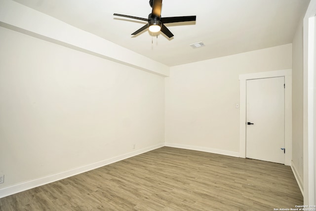 unfurnished room with hardwood / wood-style flooring and ceiling fan