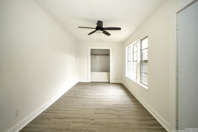 unfurnished room featuring dark wood-type flooring and ceiling fan