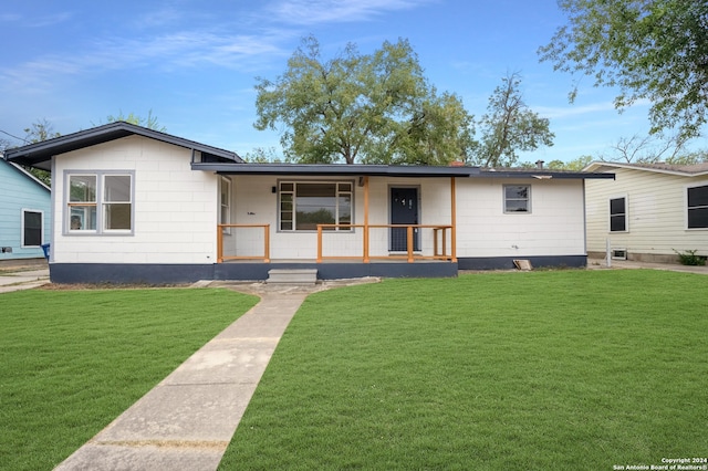 ranch-style house with a porch and a front yard