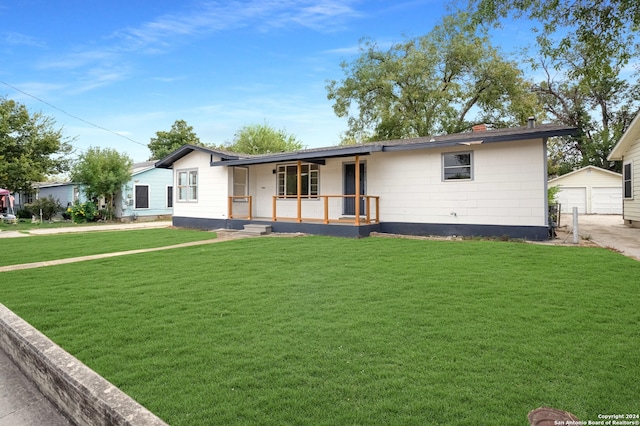 single story home with an outbuilding and a front lawn