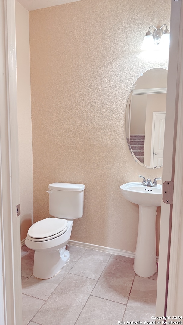 bathroom featuring tile patterned flooring, sink, and toilet