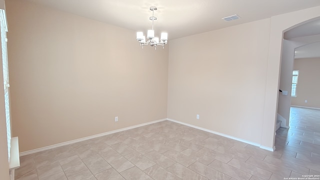 empty room with an inviting chandelier