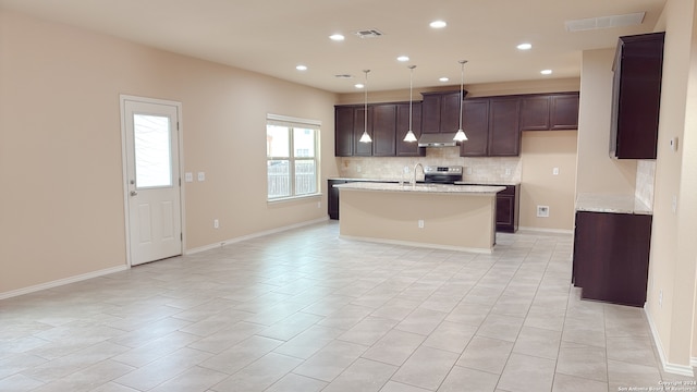 kitchen with light tile patterned flooring, backsplash, decorative light fixtures, light stone countertops, and electric range