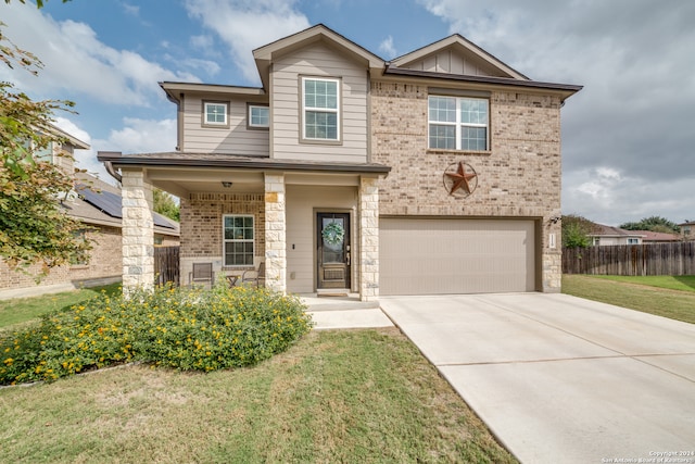 view of front of house featuring a garage and a front lawn