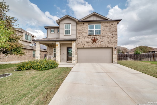 view of front of property featuring a garage and a front yard