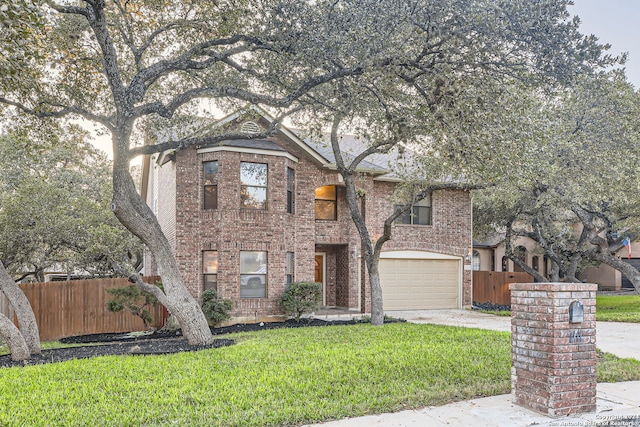 view of front of house featuring a garage and a front lawn