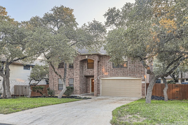 view of front of property featuring a garage and a front yard