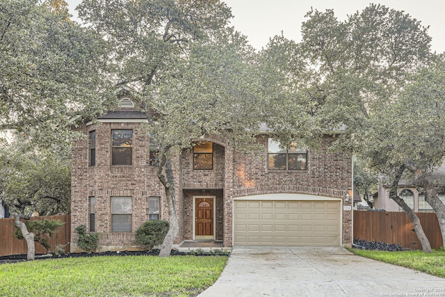 view of front of home with a garage and a front yard