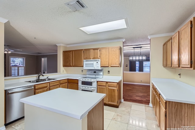 kitchen featuring white appliances, crown molding, and a kitchen island