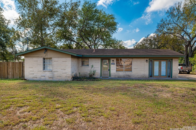 ranch-style home with a front lawn