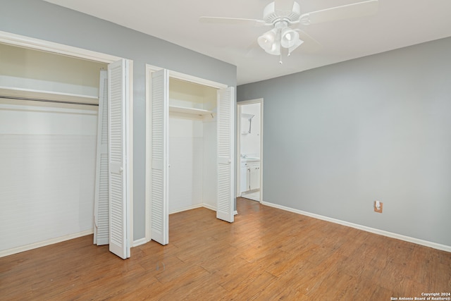 unfurnished bedroom with multiple closets, ceiling fan, and light hardwood / wood-style flooring