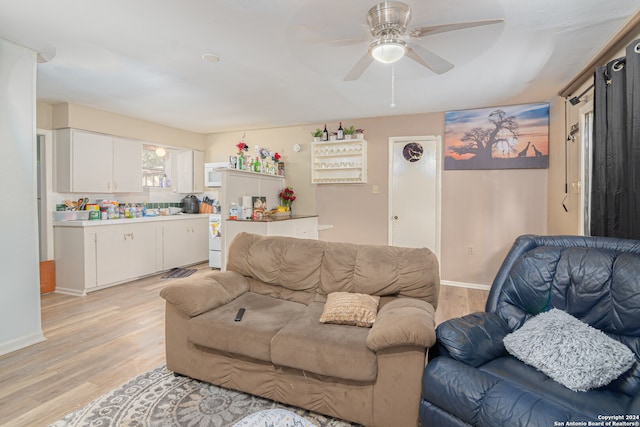 living room with ceiling fan and light hardwood / wood-style floors