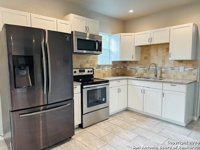 3023 Greenacres St, San Antonio, TX 78230 - kitchen featuring stainless steel appliances, white cabinetry, a sink, backsplash, and recessed lighting
