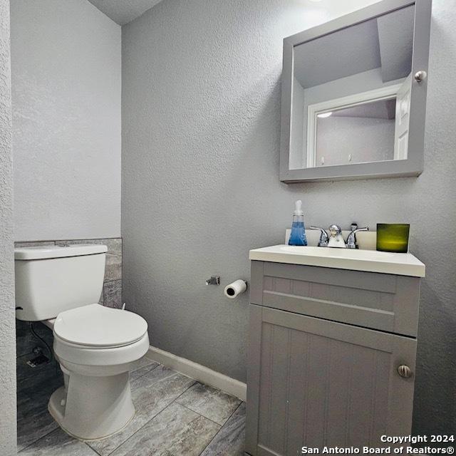 3023 Greenacres St, San Antonio, TX 78230 - bathroom with vanity, toilet, and baseboards