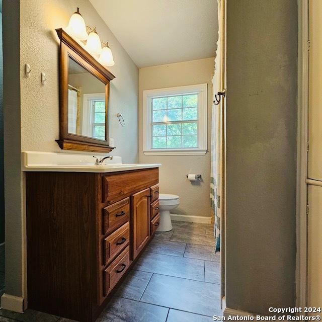 3023 Greenacres St, San Antonio, TX 78230 - full bathroom with toilet, vanity, and baseboards