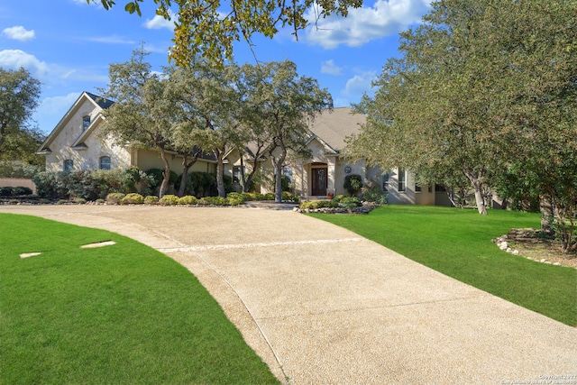 obstructed view of property featuring a front yard