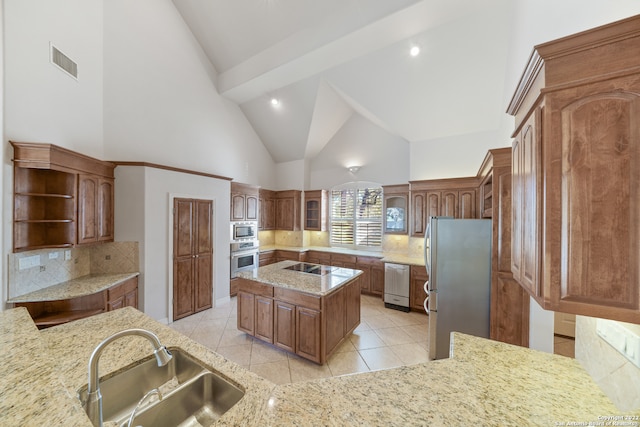 kitchen featuring sink, appliances with stainless steel finishes, backsplash, high vaulted ceiling, and a center island