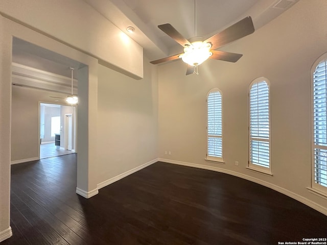 spare room featuring ceiling fan and dark hardwood / wood-style flooring