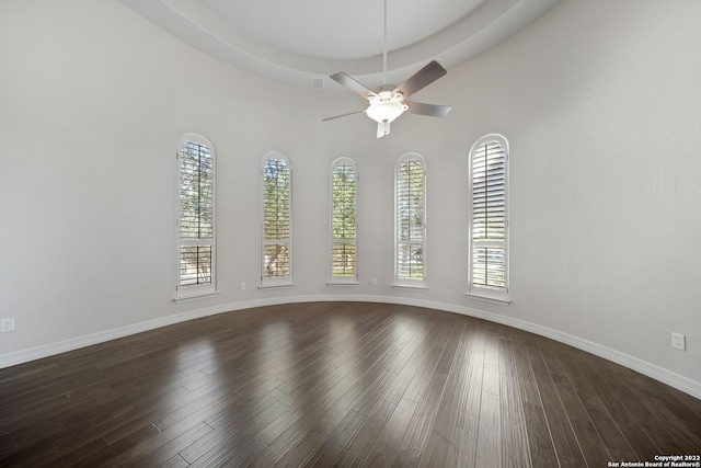 spare room featuring hardwood / wood-style floors, ceiling fan, and plenty of natural light