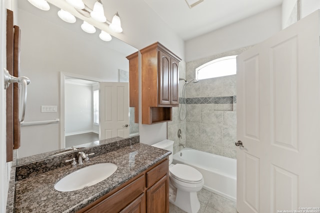 full bathroom with toilet, vanity, tiled shower / bath combo, and tile patterned floors