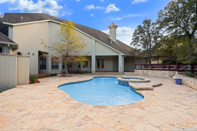 view of swimming pool with an in ground hot tub and a patio area