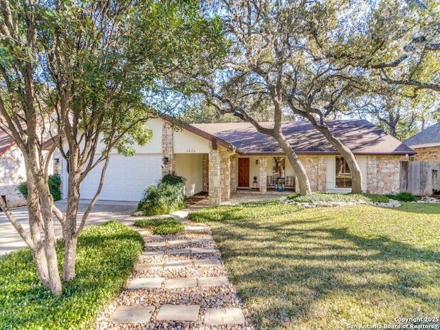 ranch-style house featuring a front yard and a garage