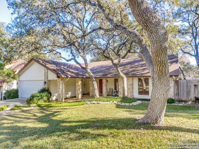 ranch-style home featuring a front lawn and a garage