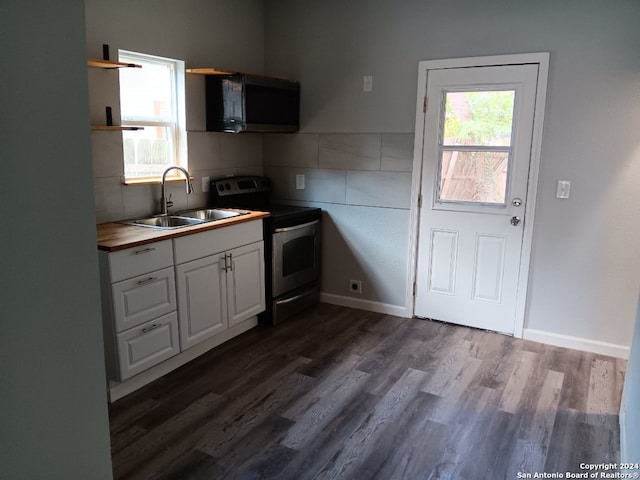 kitchen with a wealth of natural light, white cabinetry, sink, and appliances with stainless steel finishes