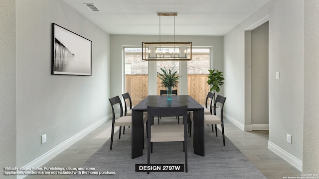 dining room with wood-type flooring and a notable chandelier