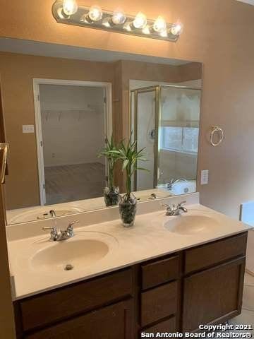 bathroom featuring vanity and a shower with shower door