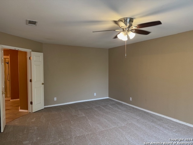 unfurnished room with carpet and ceiling fan