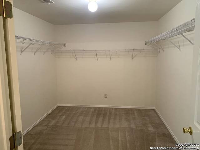 spacious closet featuring dark colored carpet