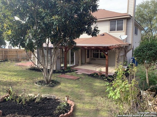 rear view of property with a patio and a yard