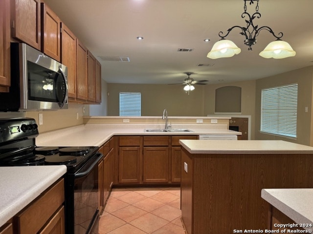 kitchen featuring sink, ceiling fan with notable chandelier, light tile patterned floors, hanging light fixtures, and black electric range oven