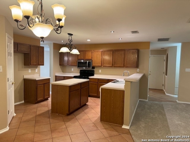 kitchen featuring sink, light tile patterned floors, an inviting chandelier, black range with gas cooktop, and pendant lighting