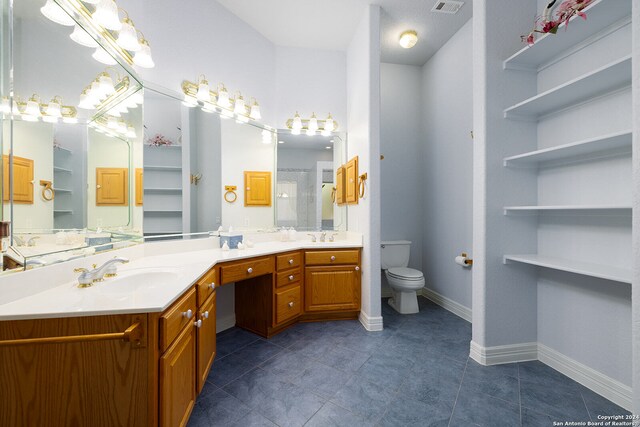 bathroom with toilet, a stall shower, a sink, double vanity, and baseboards