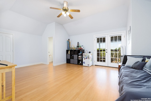 living area featuring french doors, light wood finished floors, baseboards, ceiling fan, and vaulted ceiling