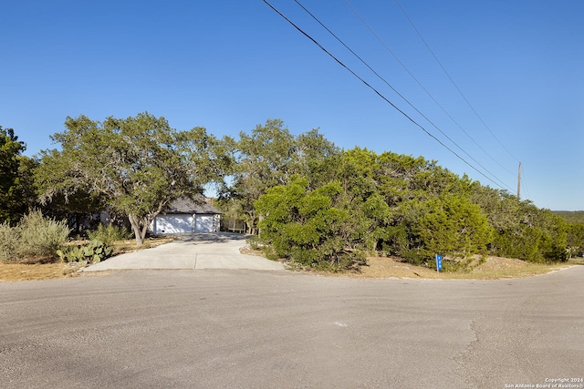 obstructed view of property with a garage