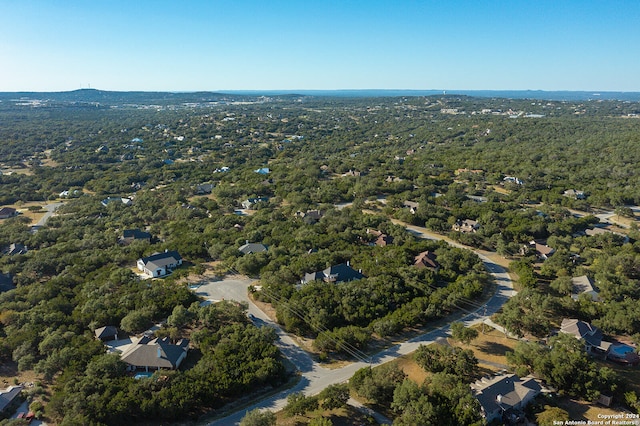 aerial view featuring a wooded view