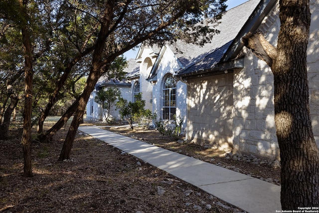 view of home's exterior with roof with shingles