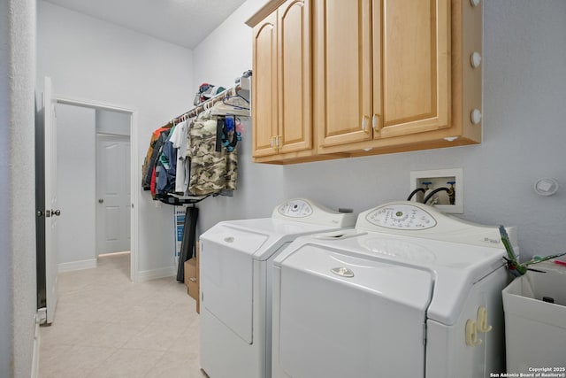 laundry area with baseboards, cabinet space, and independent washer and dryer