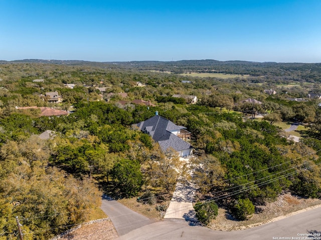 birds eye view of property with a forest view