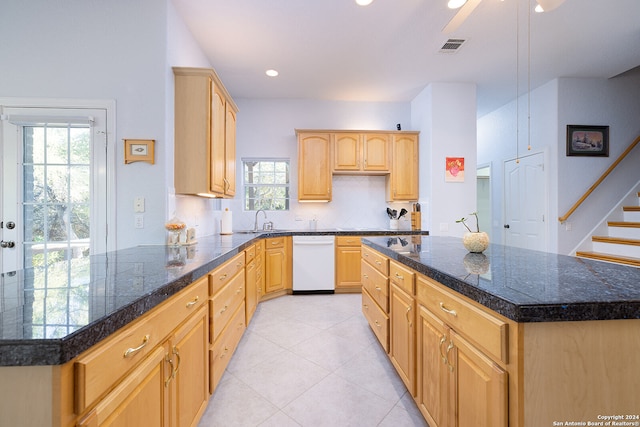 kitchen featuring light brown cabinetry, sink, dishwasher, a kitchen island, and hanging light fixtures