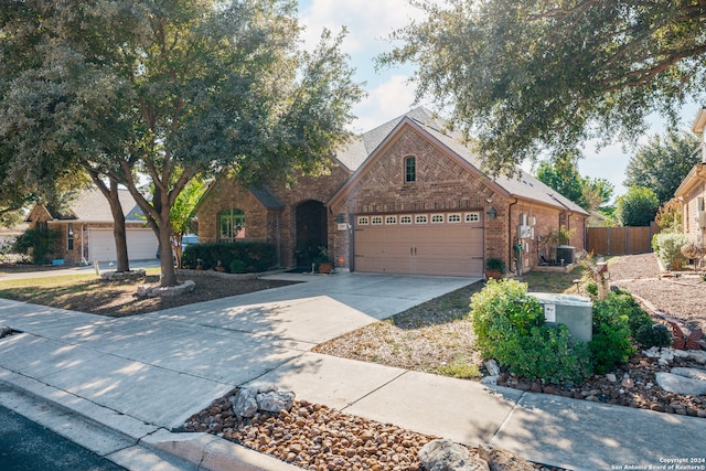 view of front facade featuring central AC unit and a garage