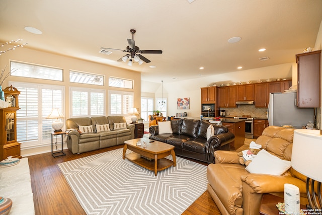 living room featuring dark wood-type flooring and ceiling fan