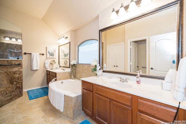 bathroom with tile patterned flooring, vanity, and lofted ceiling